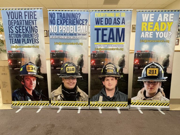 Four recruitment banners for Evans Center Fire Department show firefighters in gear, fire trucks, and slogans encouraging teamwork and new volunteers, with contact info at evanscenterfd.org.