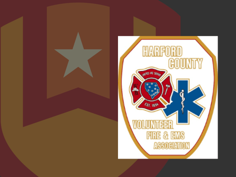Harford County Volunteer Fire & EMS Association logo featuring a red fire department emblem, blue medical symbol, and gold text on a white badge-shaped background.