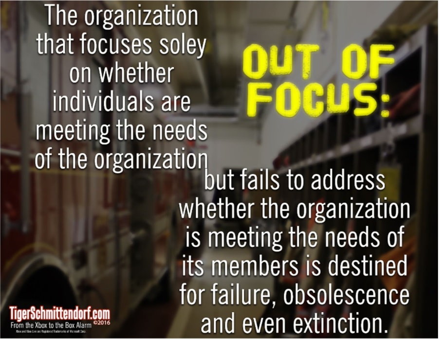 A blurred firehouse hallway with lockers and hoses. Overlaid text reads: “The organization that focuses solely on whether individuals are meeting the needs of the organization, but fails to address whether the organization is meeting the needs of its members is destined for failure, obsolescence, and even extinction. OUT OF FOCUS.”.