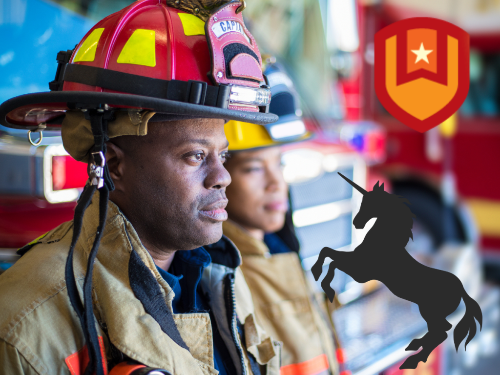 Two firefighters in uniform stand in front of fire trucks. A red shield with a gold star and a black unicorn silhouette appear over the image.