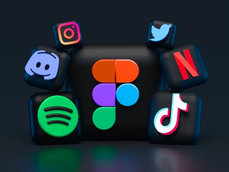 3D black cubes displaying logos of popular apps: Instagram, Twitter, Discord, Netflix, Spotify, TikTok, and Figma (center), arranged against a dark background.