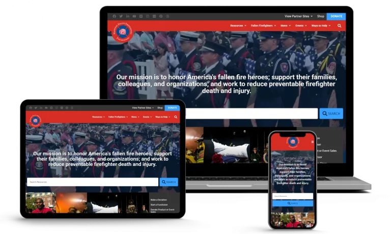 A website about honoring fallen fire heroes is displayed on a laptop, tablet, and smartphone, showing uniformed firefighters in a ceremony and the mission statement overlaid on the homepage.