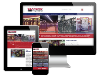 A desktop computer, tablet, and smartphone display the responsive website of GearGrid Corporation, featuring the company logo and images related to storage solutions for public safety and automotive industries.