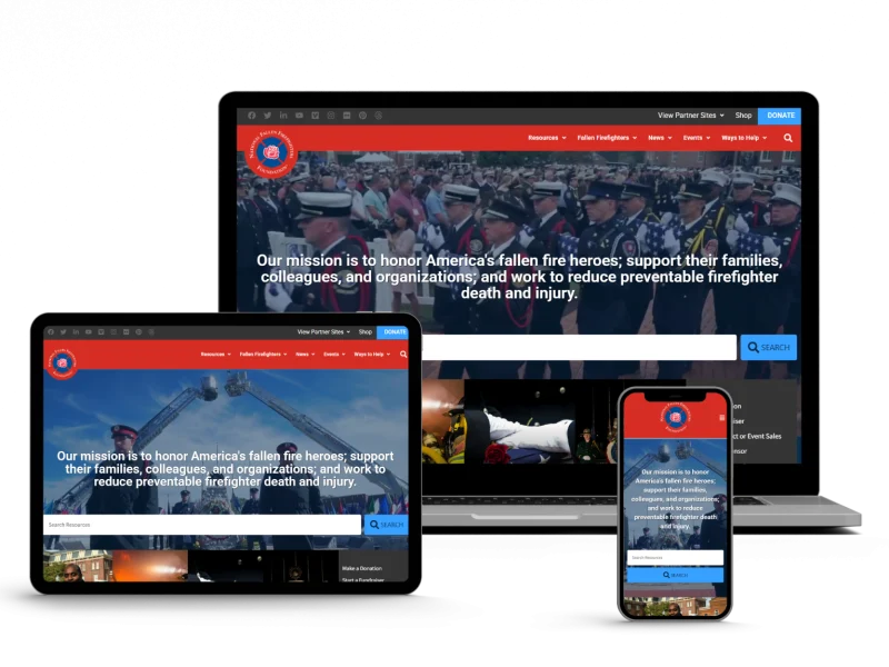 A laptop, tablet, and smartphone display a website honoring America’s fallen firefighters, with a banner image of uniformed firefighters and a mission statement about preventing firefighter death and injury.