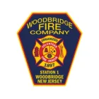 Badge-shaped patch for Woodbridge Fire Company, Station 1, Woodbridge, New Jersey. It features a red and yellow fire rescue emblem, the words "Volunteer Fire-Rescue," and the year 1897 on a dark blue background.